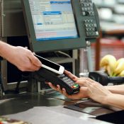 Cropped image of cashier woman create payment with phone app.